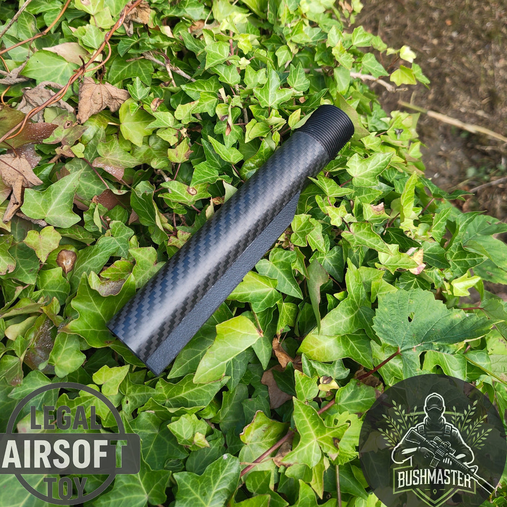 Carbon fiber textured airsoft suppressor on green ivy leaves background with Bushmaster logo
