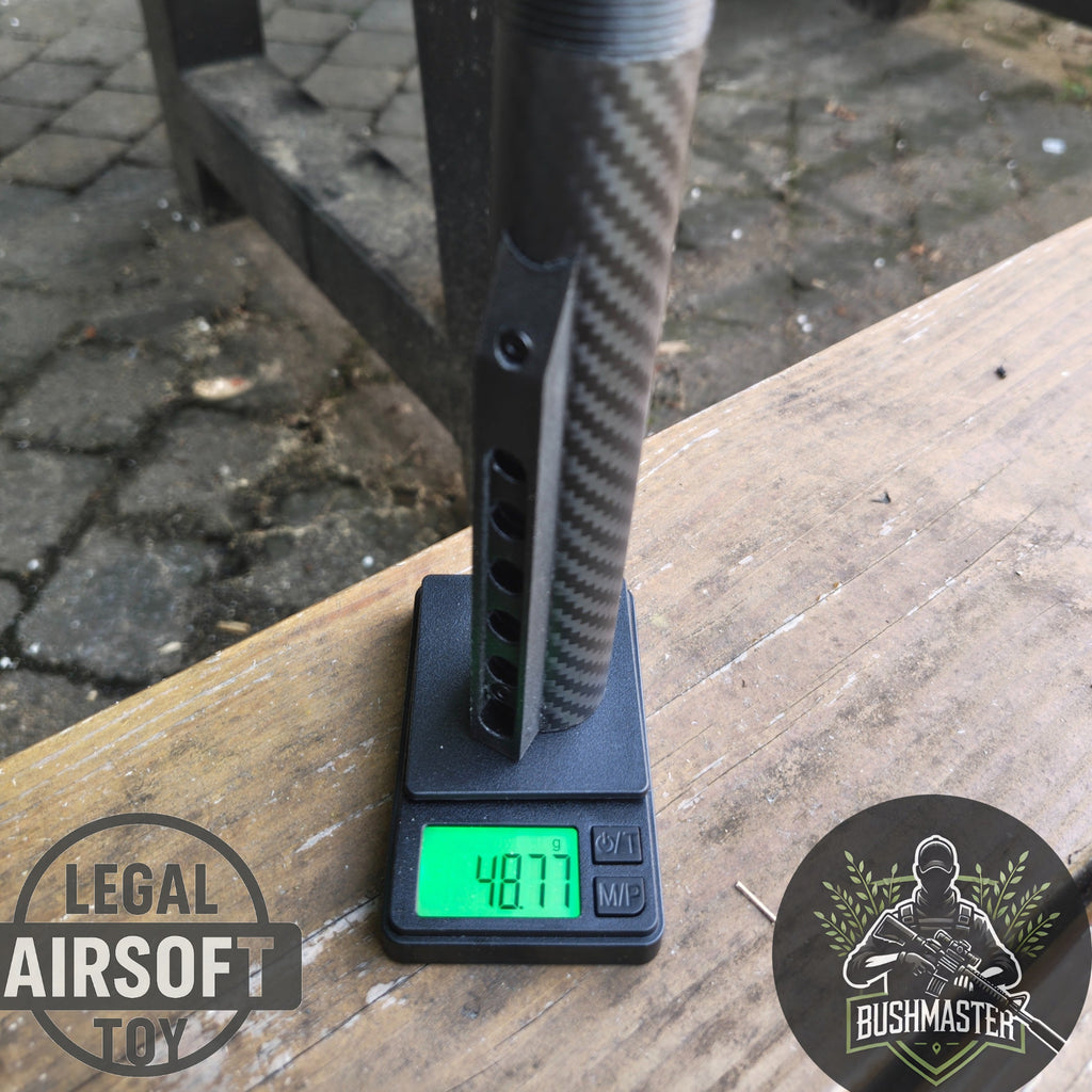 Carbon fiber airsoft gun part weighing 48.77 grams on digital scale outdoors