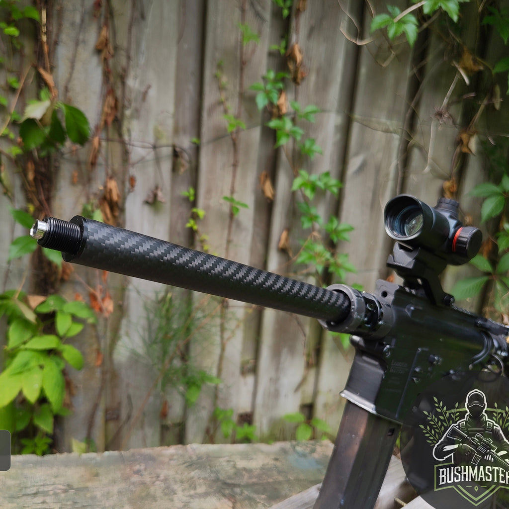 Close-up of a Bushmaster rifle with carbon fiber suppressor and scope on wooden table outdoors