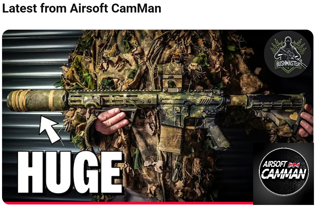 Airsoft CamMan holding a camouflage airsoft replica fitted with the Bushmaster Big Boy sound moderator
