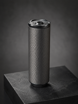 Bushmaster Big Boy Gen 3 carbon-fiber airsoft sound moderator standing on a dark display pedestal