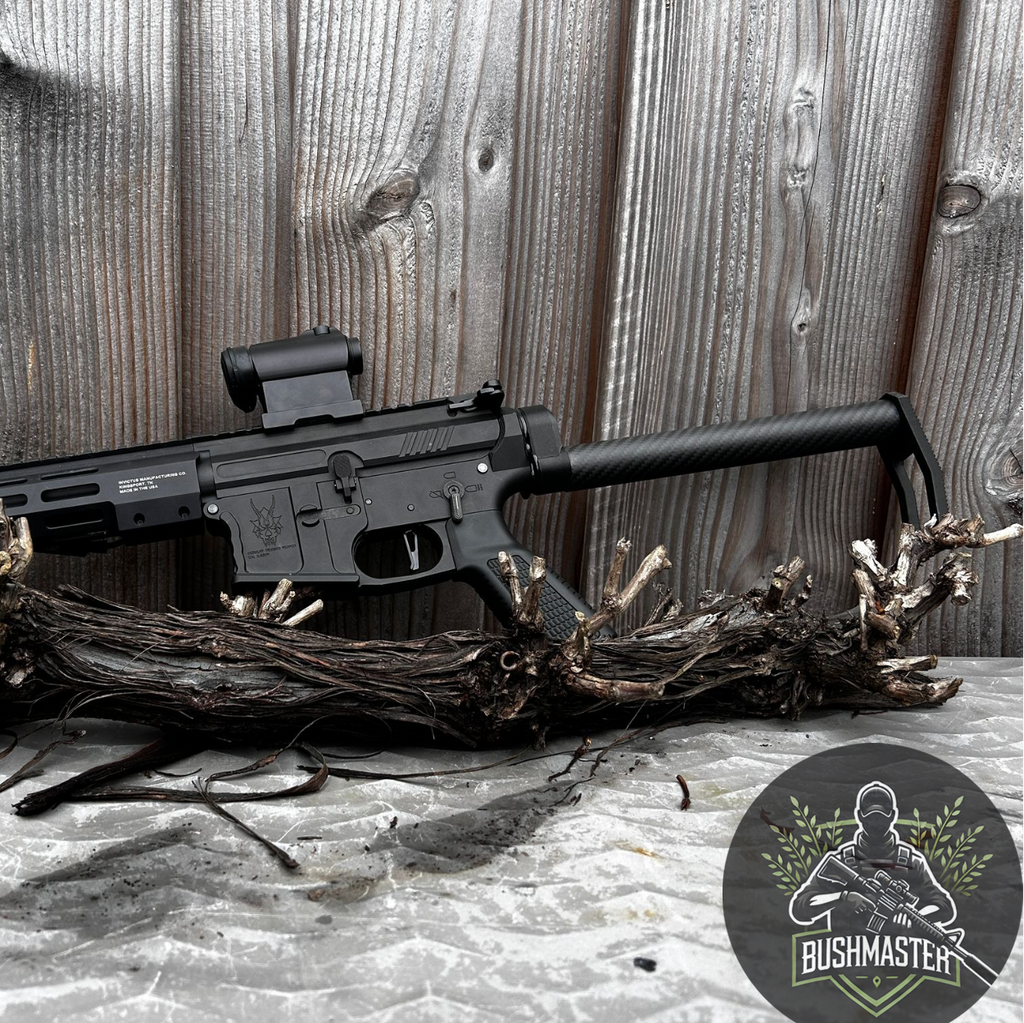 Black Bushmaster rifle resting on wooden roots against weathered wood background with Bushmaster logo