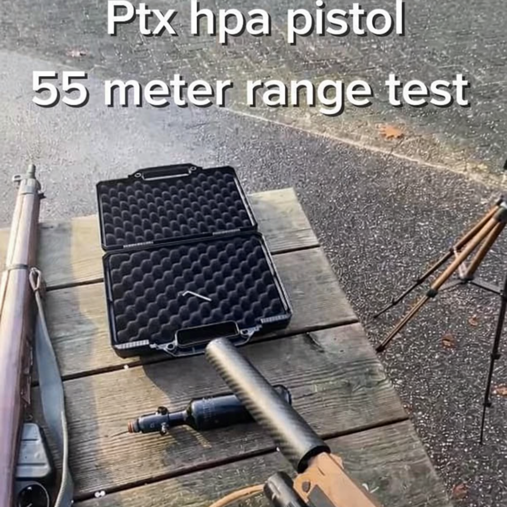 Ptx HPA pistol and accessories on wooden table during 55 meter range test outdoors